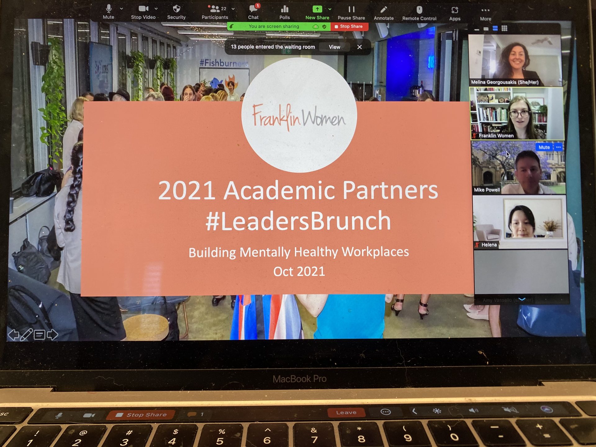 Laptop screen of Zoom event. Shared slides reads2021 Academic Partners #LeadersBrunch, Building Mentally Healthy Workplaces, October 2021. Videos of some participants are visible along the side of the screen.