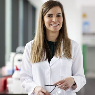 Professor Francine Marques wearing a white lab coat